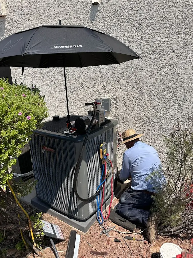 HVAC technician performing outdoor AC maintenance in Waunakee